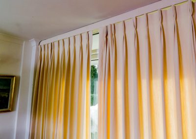 Full length cream curtains with triple pleats