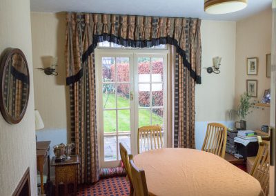 Full length curtains matching fringed draping pelmet