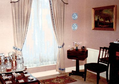 Full length, tied-back curtains with matching pelmet