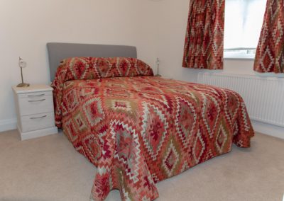 Red & green diamond patterned bed throw with matching curtains
