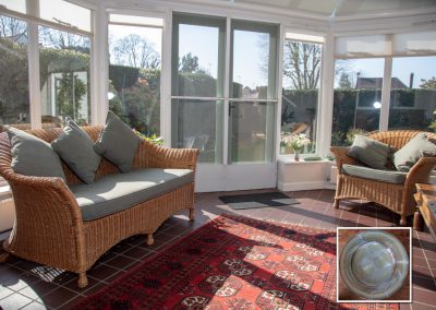 Upholstery on cane sofa & chair with matching square cushions
