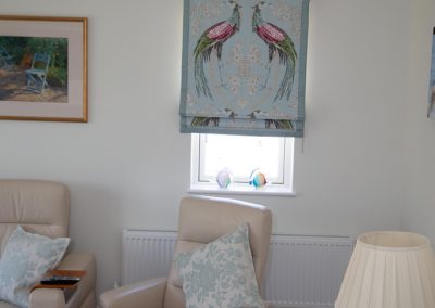 Framed roman blind with pair of peacocks