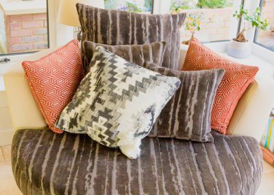 Round chair with velvet seat and array of cushions